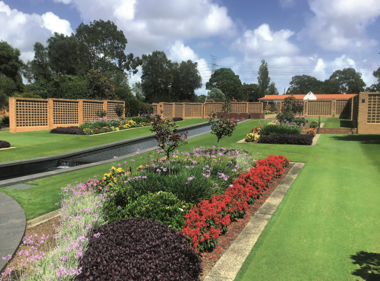 Cemetery garden with flowers in foreground