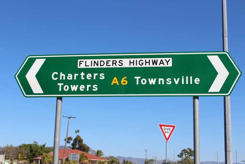 Road sign saying Flinders Highway and Charters Towers and Townsville