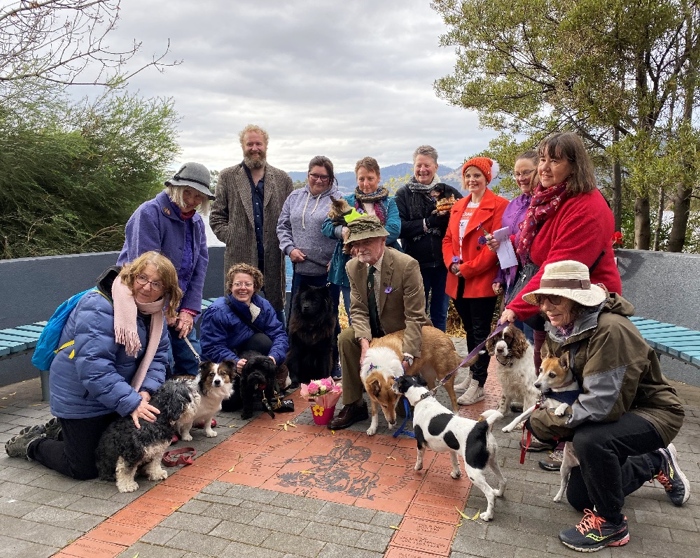 Group of people with their dogs at a memorial