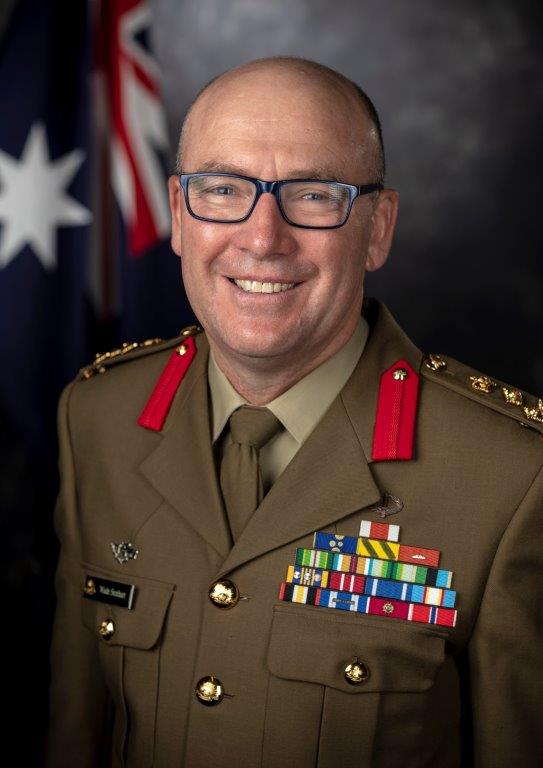 Studio portrait of smiling middle-aged man in Brigadier's dress uniform