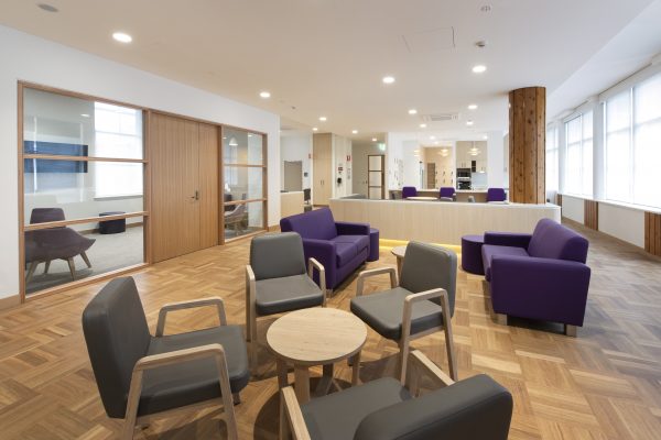 Spacious interior with lounge chairs on timber floor