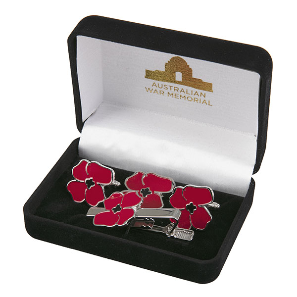 Display box containing various bits and pieces with enamelled red poppies.