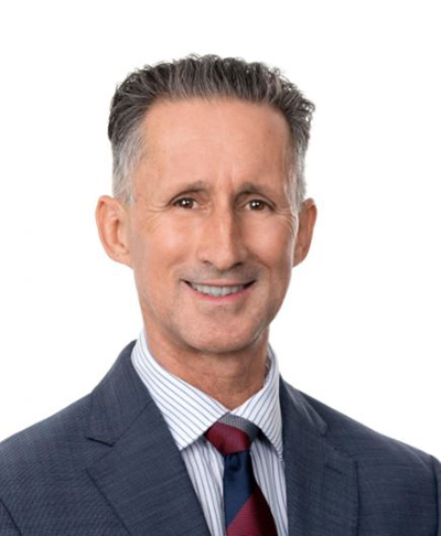 Portrait photo of middle aged man in suit smiling