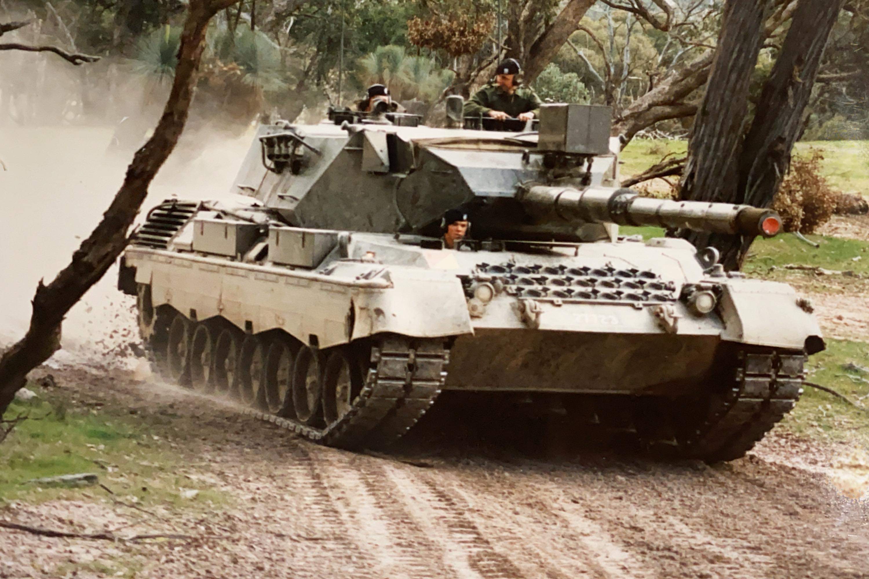 Tank driving down dirt road