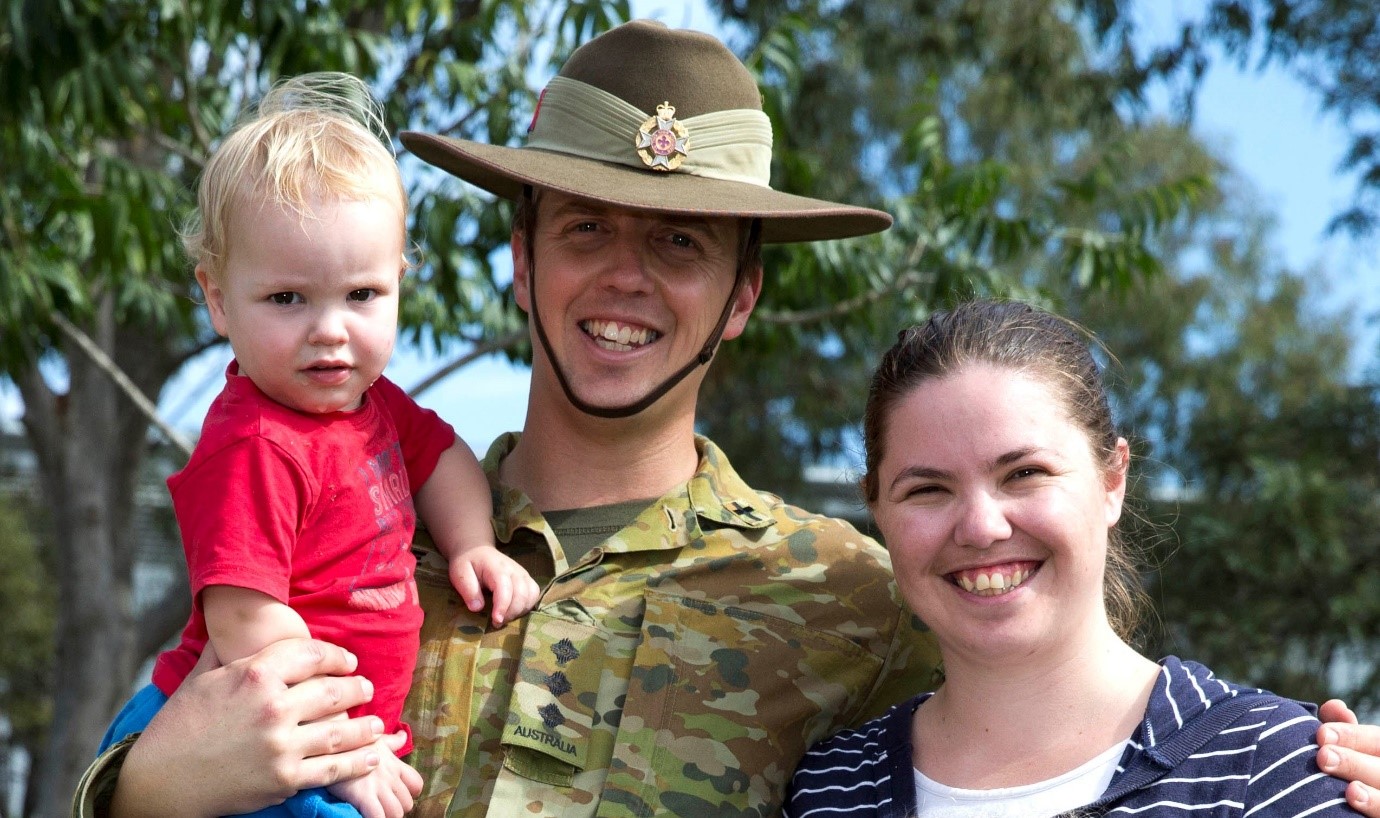 Army captain with female partner and toddler son all smiling