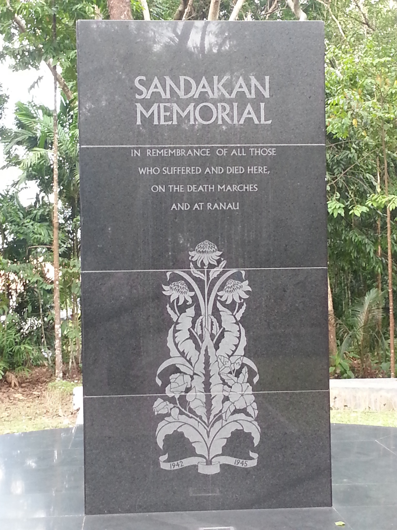 Obelisk saying 'Sandakan Memorial - In memory of all those who suffered and died here, on the death marches and at Ranau'