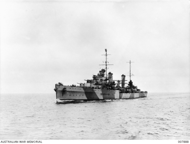 A cruiser with dazzle paint at sea in a black and white image.