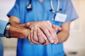 Nurse holding a patient's hand