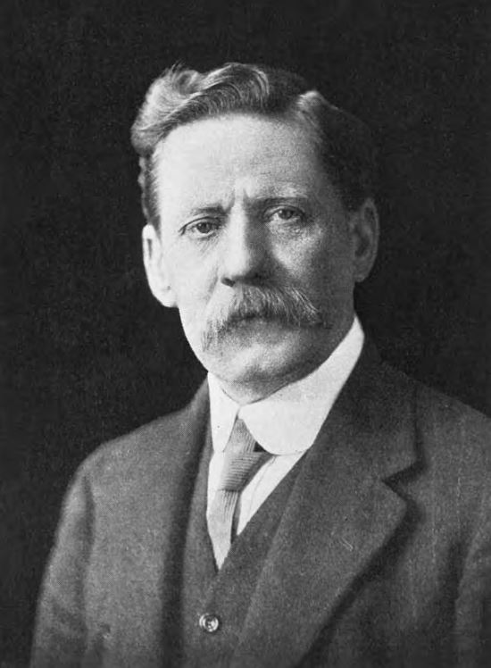 Portrait photo of middle-aged man with a moustache