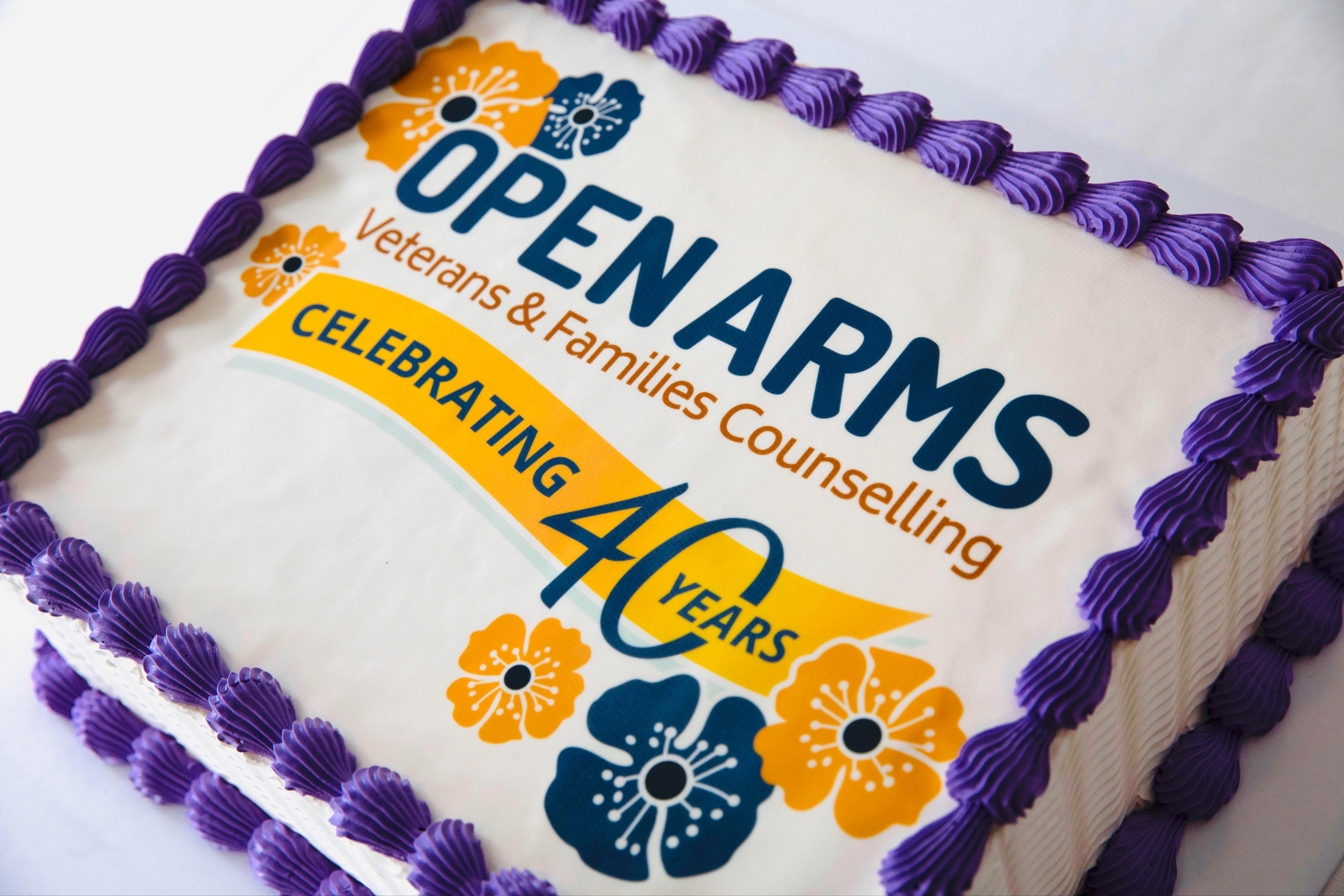 Square cake in Open Arms colours and the words: 'Open Arms celebrating 40 years'