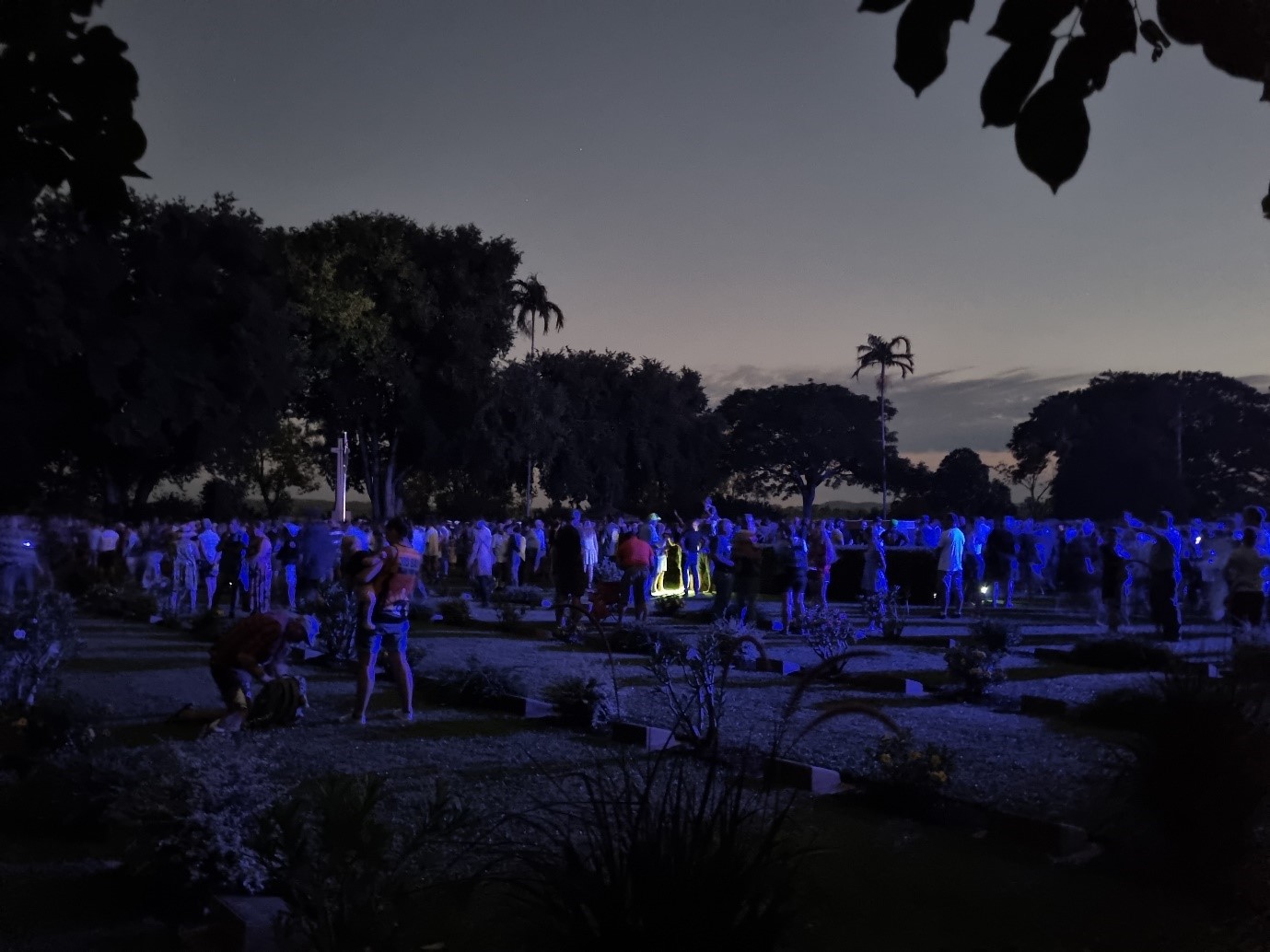 People gathered at cemetery in the dark