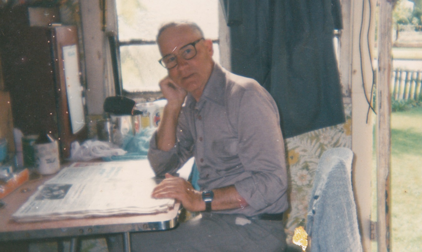 Older man at desk in his house