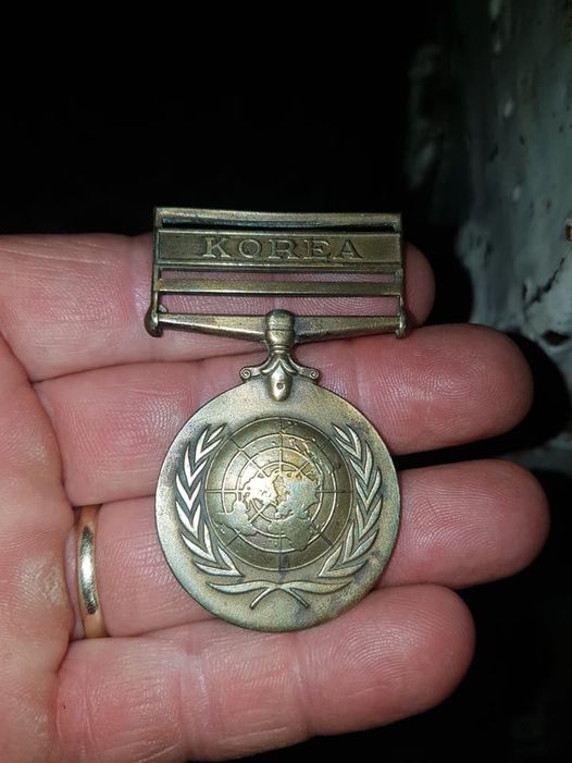 Medal without a ribbon on someone's hand