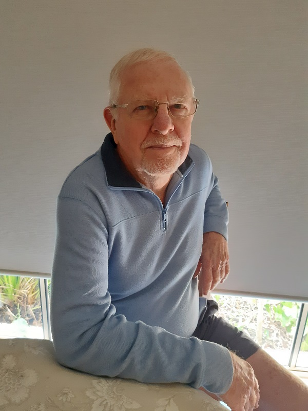 An older man sitting at table in a home