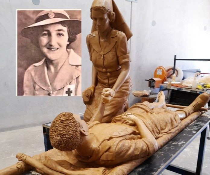 Sculpture showing nurse holding hand of soldier on stretcher