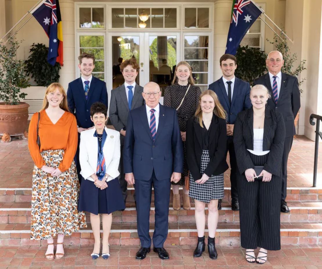 Three adults and seven teenagers pose for camera on steps of Government House, Canberra