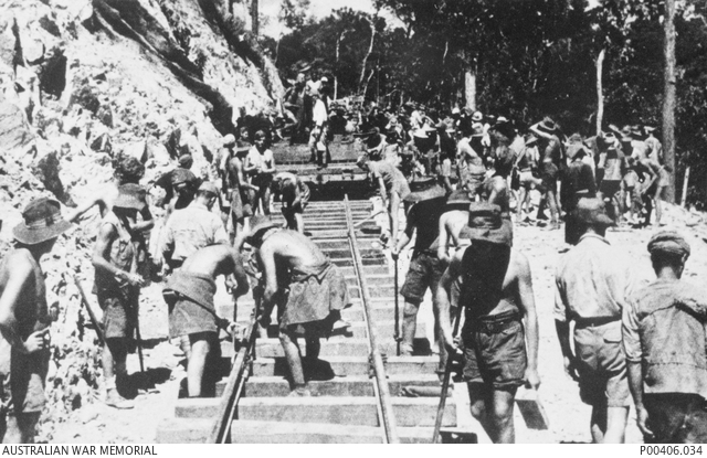 A hundred or so Australian soldiers working on track next to cutting