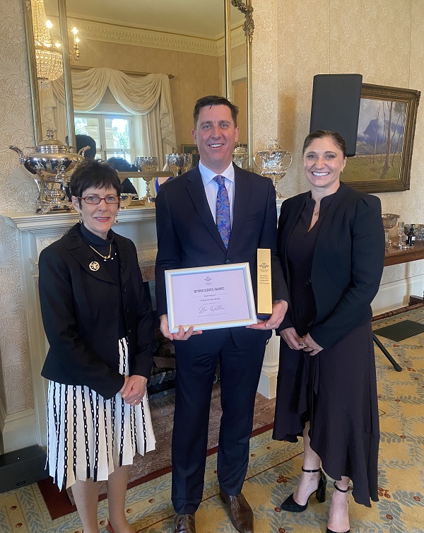 three people pose in fancy state room