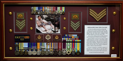 Medals, insignia and photo in display frame