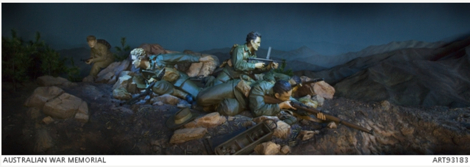 Diorama showing three soldiers fighting at night in a defensive position