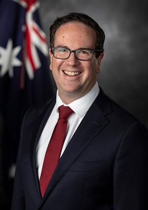 Studio portrait of smiling middle-aged man with Australian flag in background