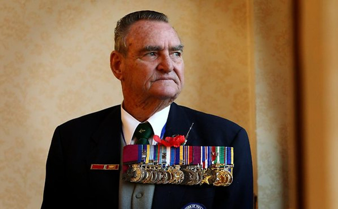 Older man in formal dress wearing large number of medals including the Victoria Cross