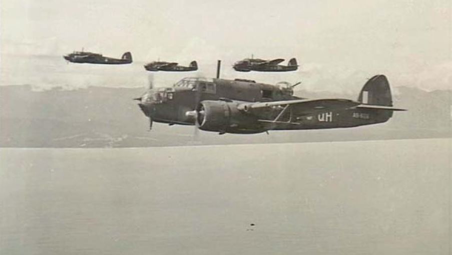 Four second world war bombers in flight off the coast