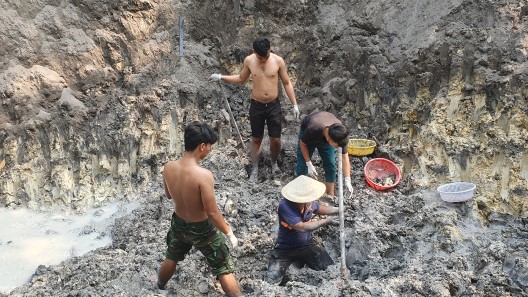 Workers at burial location of fallen Vietnamese soldiers