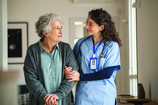 Young female doctor with elderly female patient