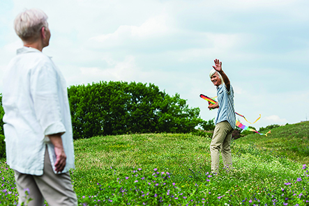 Older people in field with kite