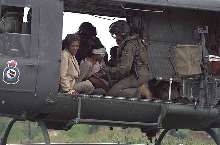 Wounded Timorese assisted by army personnel on board of a helicopter.