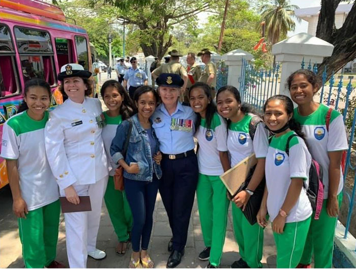 Timorese school girls with two women dressed in military uniform