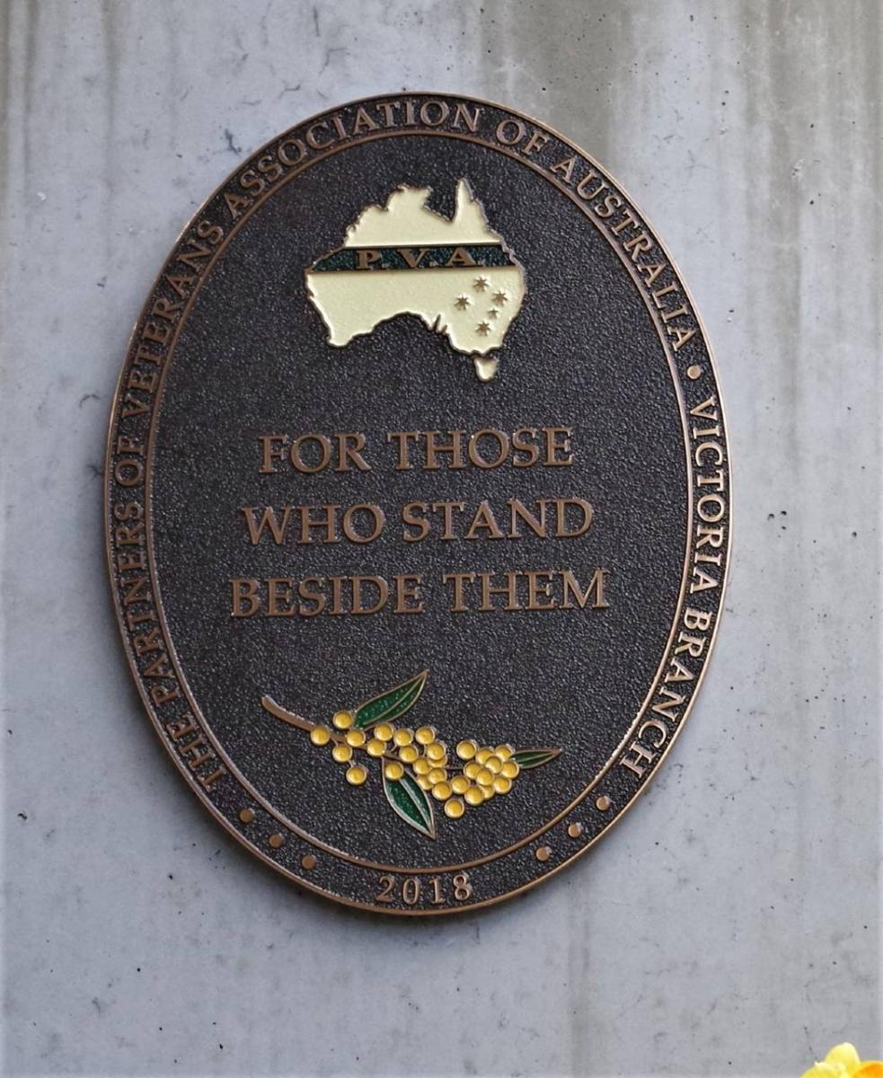 A bronze plaque whose principal inscription is: ‘For those who stand beside them’.