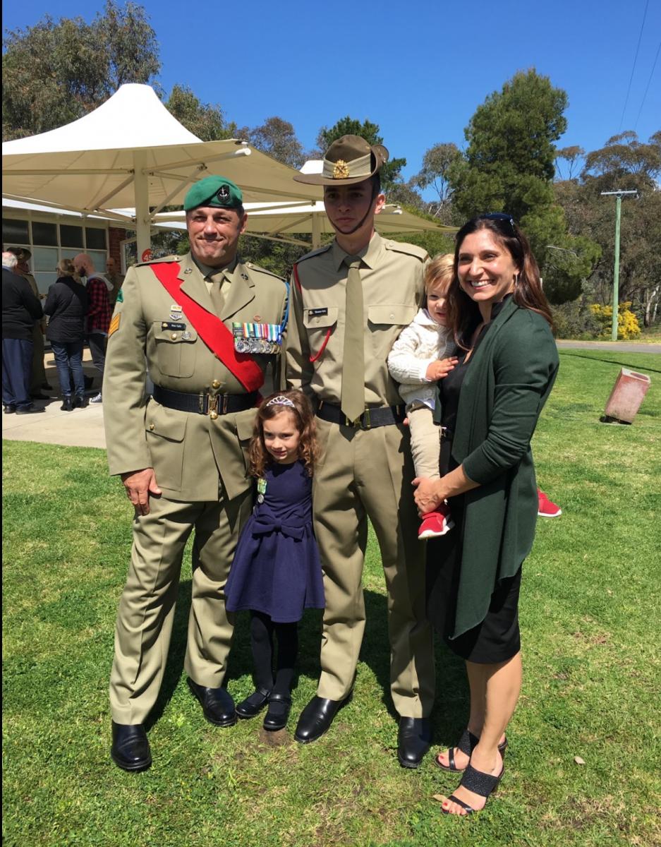 Two men in Army uniform, a woman and two children.