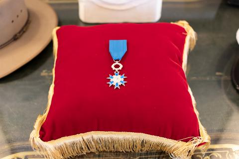 Blue medal resting on red cushion